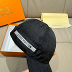Black baseball cap with quilted grid texture and woven interior logo strap