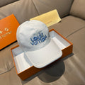Louis Vuitton white cap with blue stitched logo on front, curved brim