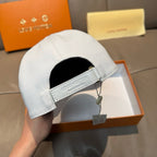 Louis Vuitton white cap with black inner panel and fabric brand label on band