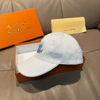 Louis Vuitton white cap with blue logo, front-left view