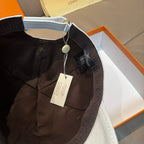 Louis Vuitton black cap with adjustable strap and hanging tag, inside view