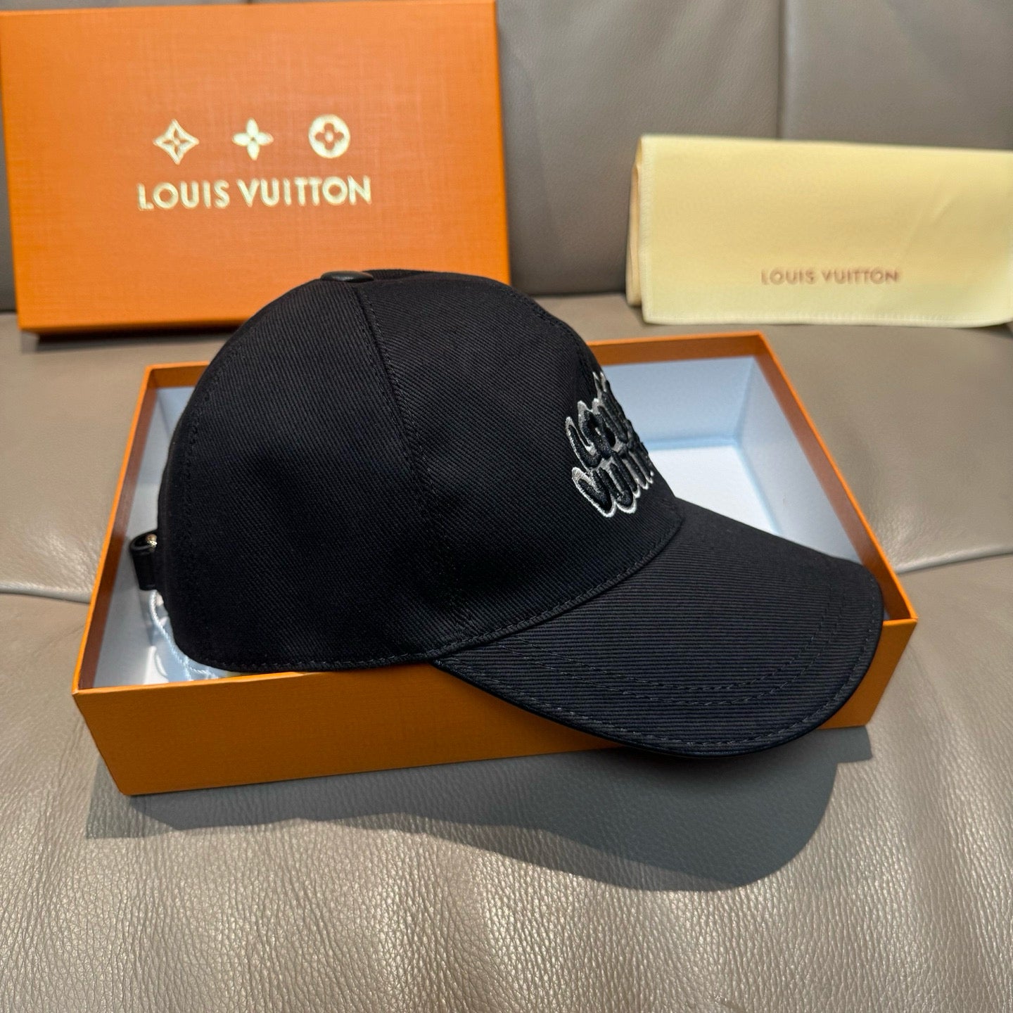 Black Louis Vuitton baseball cap with side embroidered script logo