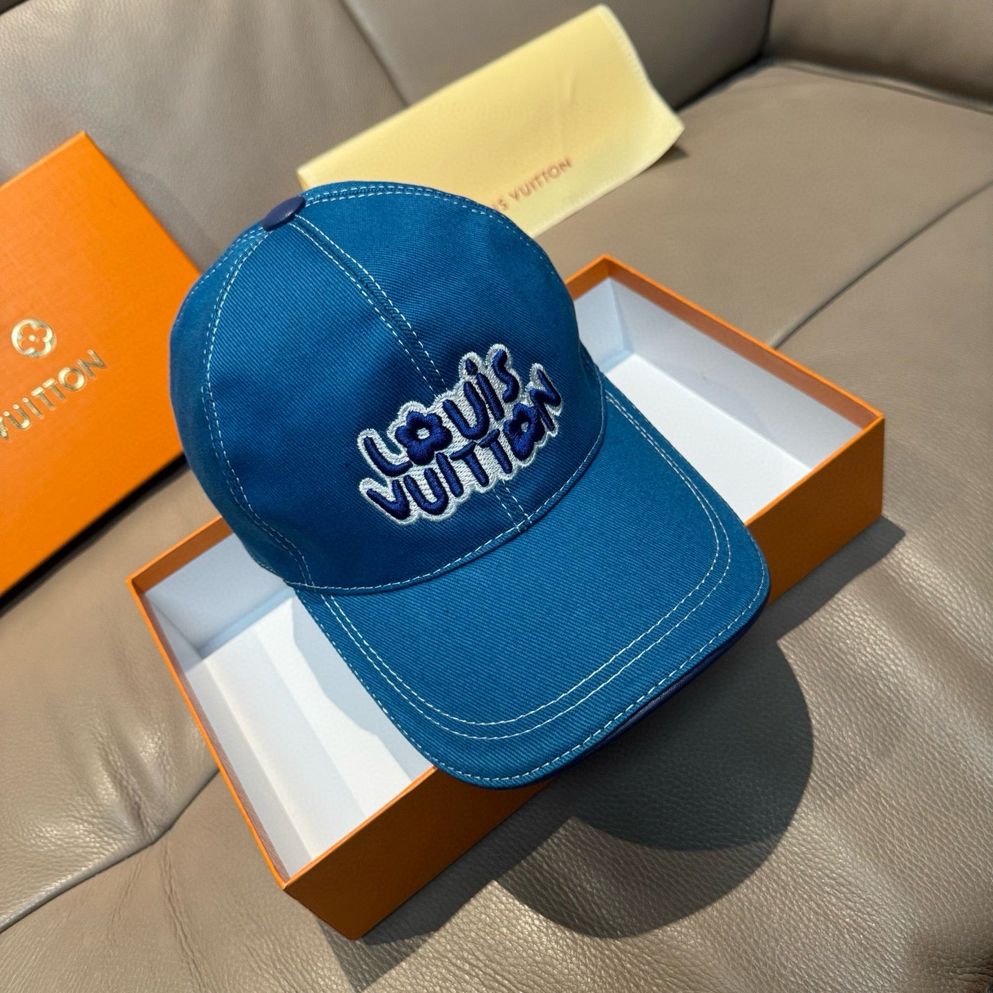 Blue denim Louis Vuitton cap with curved brim and embroidered Louis Vuitton logo
