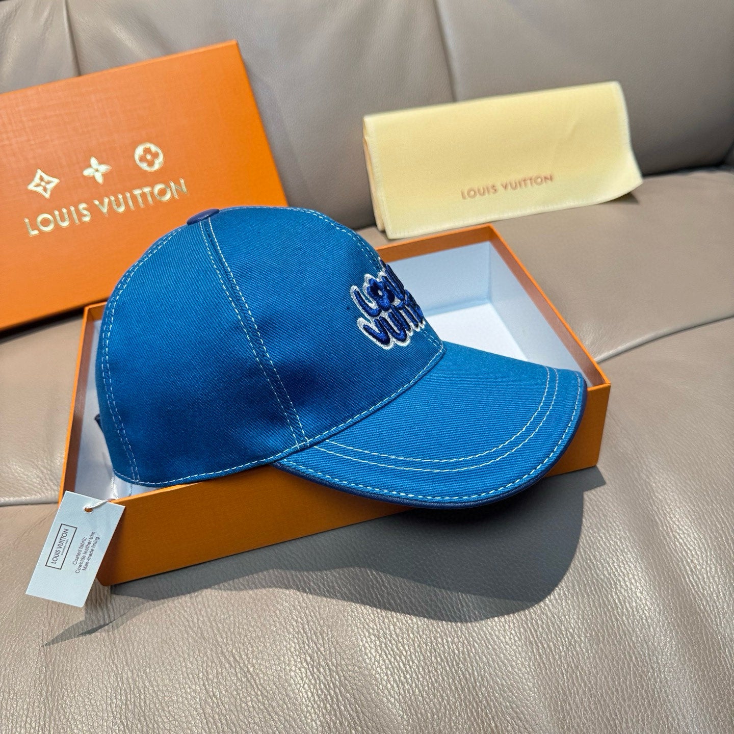 Blue denim Louis Vuitton cap with embroidered front logo and curved stitched brim