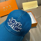 Blue denim cap close-up with embroidered Louis Vuitton logo on the front