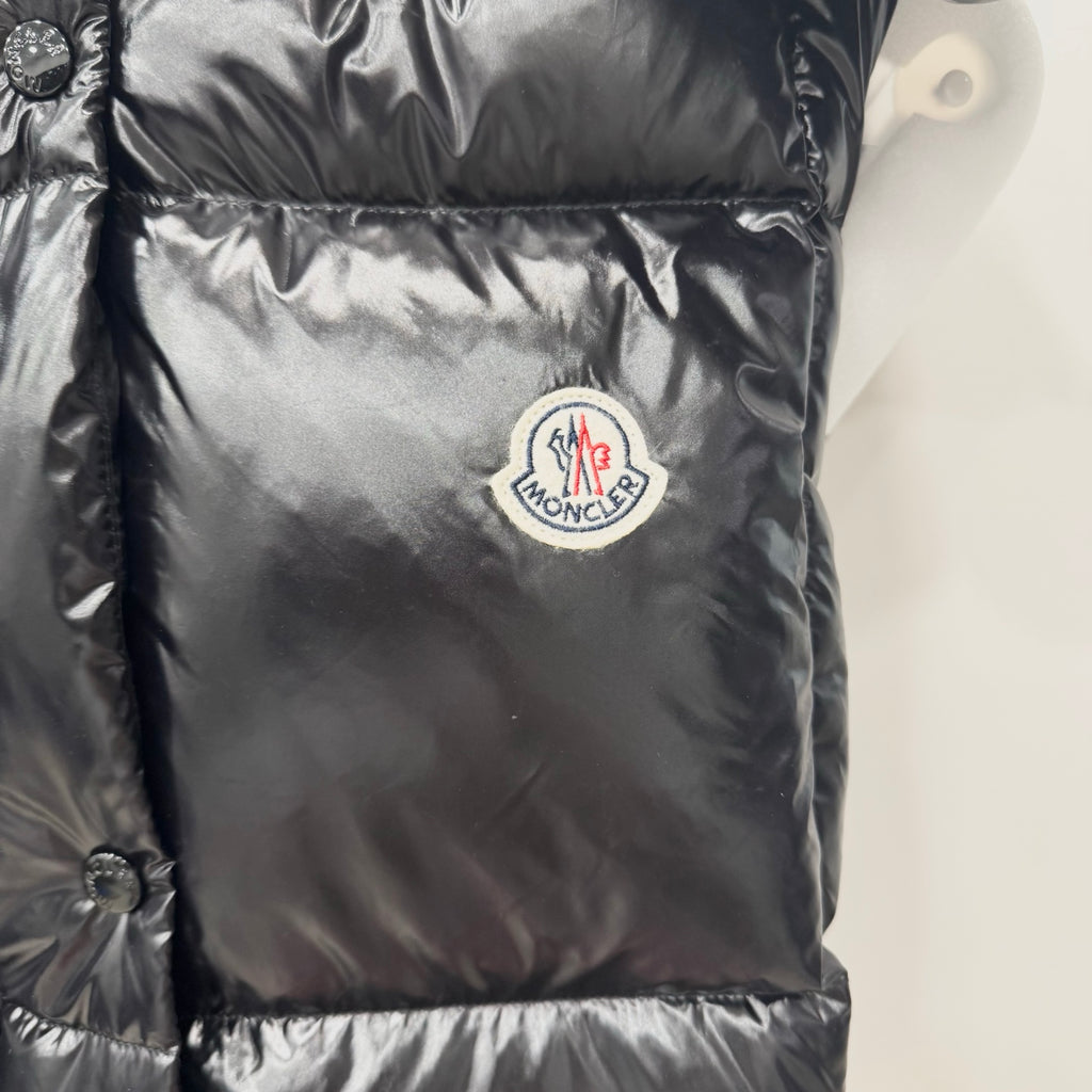 Moncler long puffer jacket front logo patch on shiny dark quilted fabric