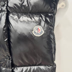 Moncler long puffer jacket front logo patch on shiny dark quilted fabric