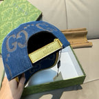 Gucci denim cap in blue with GG pattern, black lining, and gold Gucci label