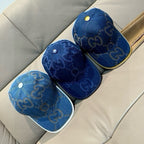 Gucci cap set with blue GG denim, yellow-trim brims, and small button tops