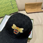 Black Gucci baseball cap with gold bee badge and multicolor crest