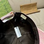 Inside view of pink baseball cap showing black band and Gucci-branded label