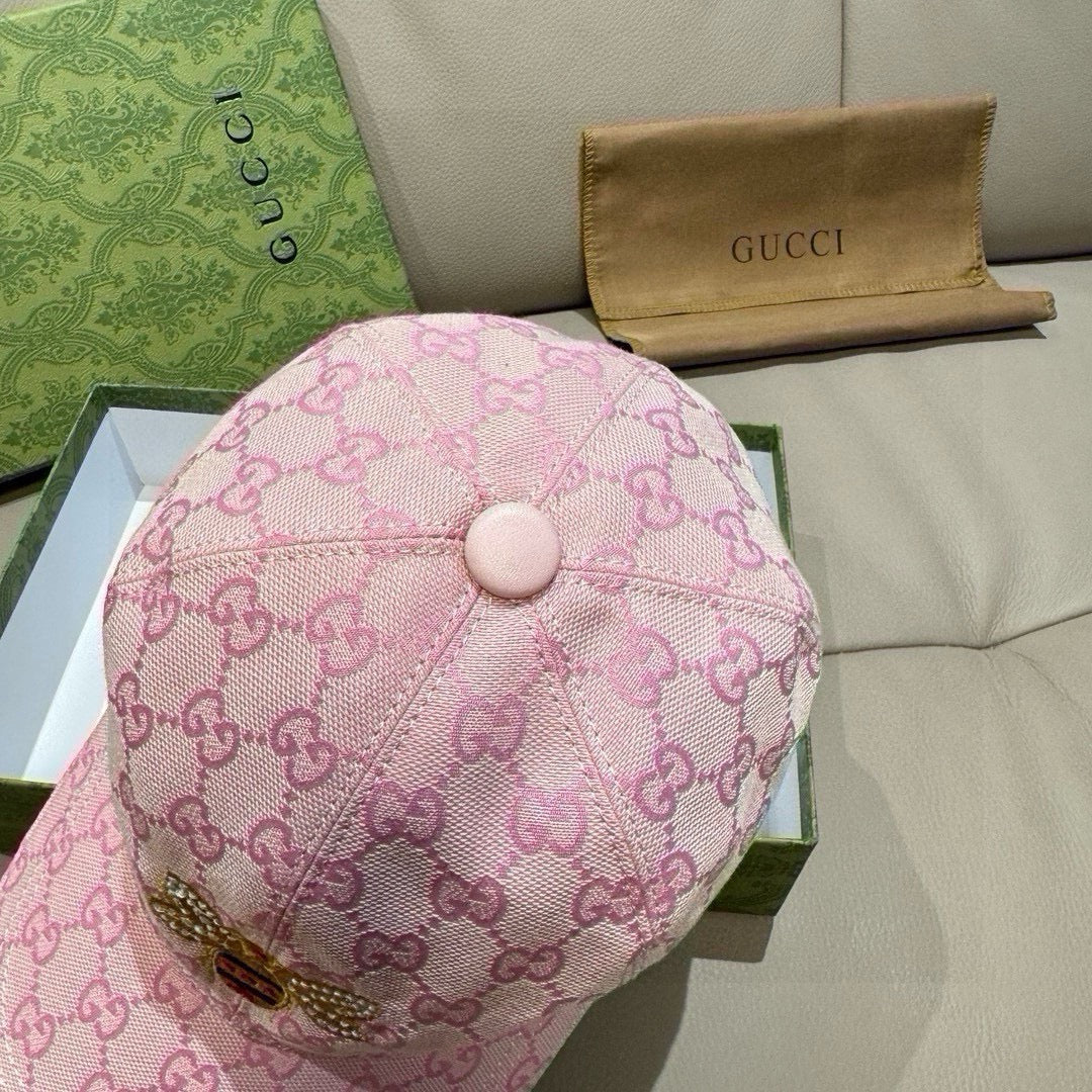 Pink baseball cap with GG-style monogram print and round button at top