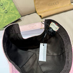 Pink baseball cap interior with black lining, adjustable strap, and hanging tags