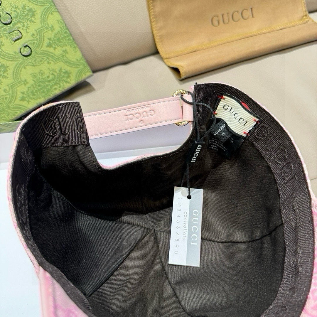 Pink baseball cap interior with black lining, adjustable strap, and hanging tags