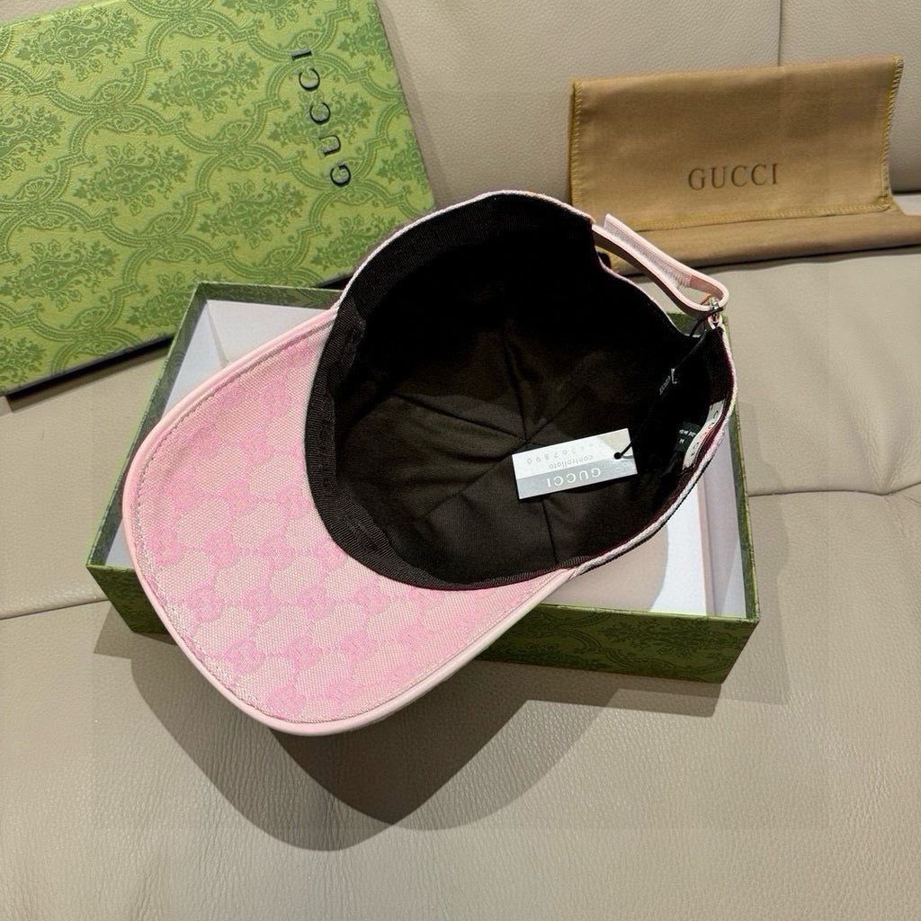 Pink baseball cap with black interior lining and curved brim