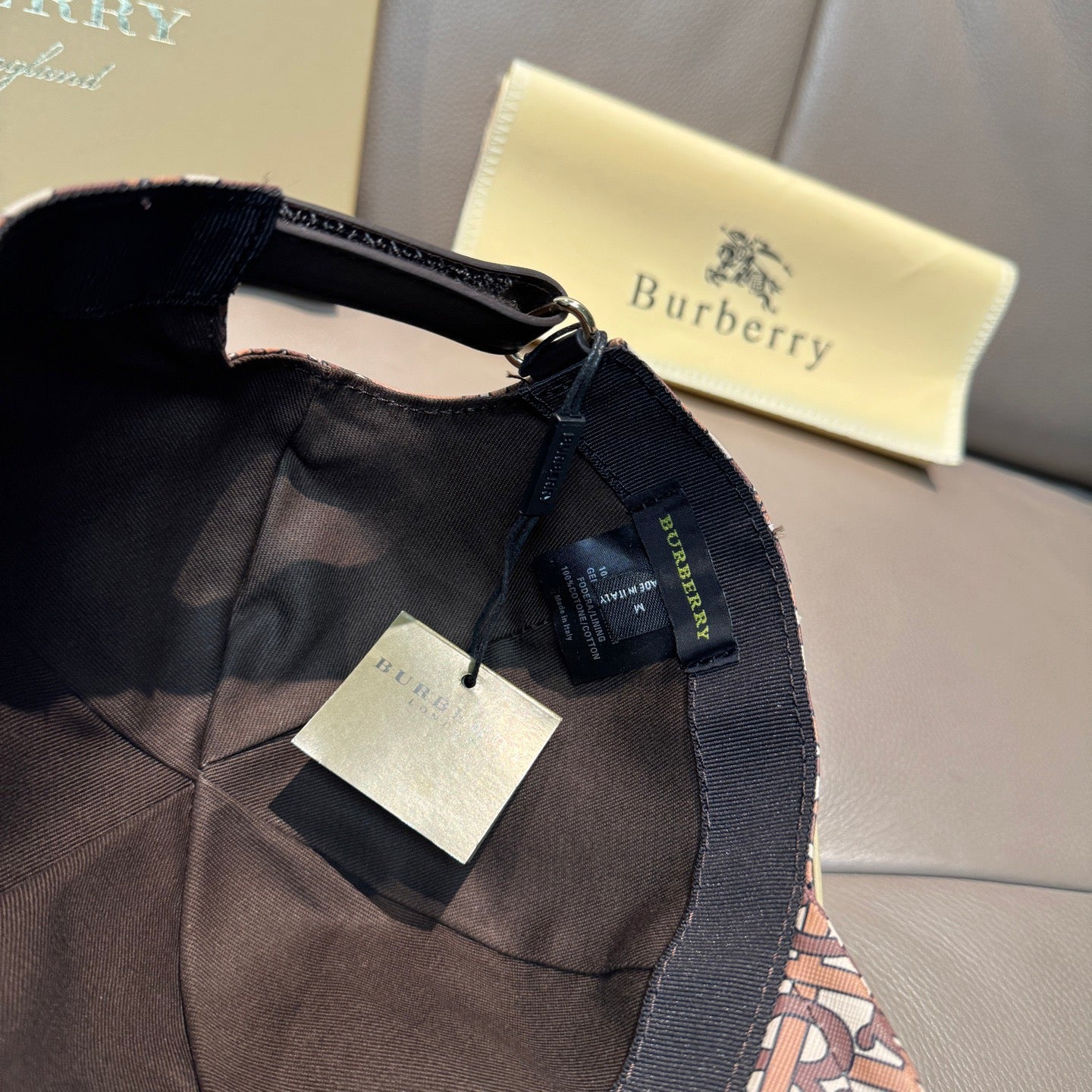 Burberry cap interior with black mesh lining, adjustable strap and tags