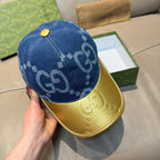 Gucci blue GG denim baseball cap with gold button and yellow brim