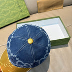 Gucci blue GG denim baseball cap top view with gold button