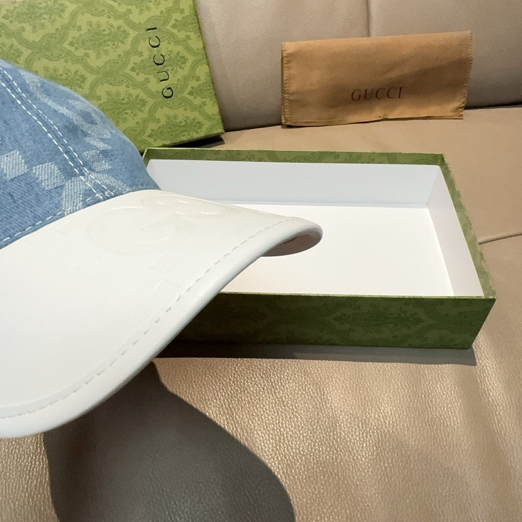 White Gucci cap with textured embossed GG pattern on brim