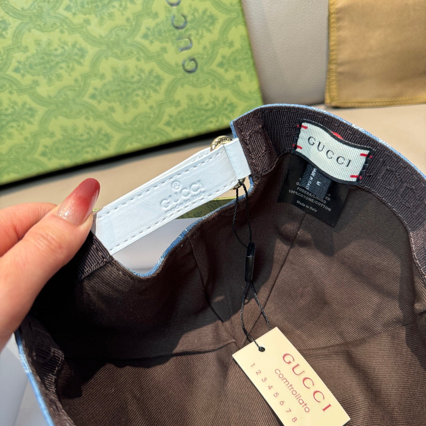 Black Gucci cap interior with adjustable strap and hanging price tag