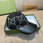 Dark GG monogram baseball cap with black leather front panel and curved brim