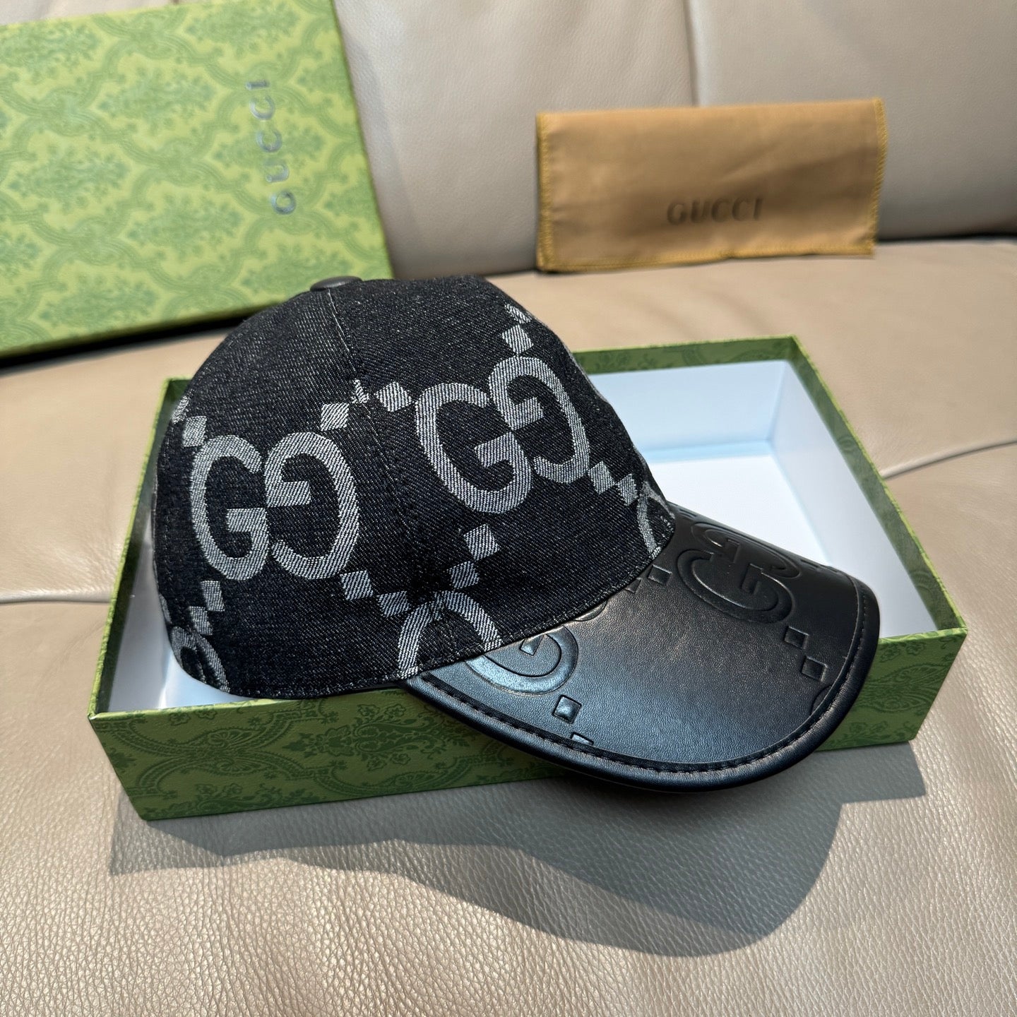 Dark GG monogram baseball cap with black leather front panel and curved brim