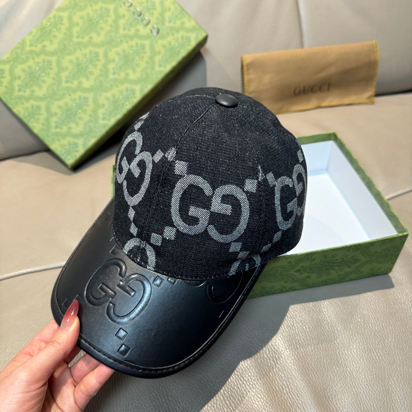 Dark GG monogram baseball cap with black leather front panel and curved brim