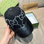 Dark GG monogram baseball cap viewed from side, with stud and black leather brim