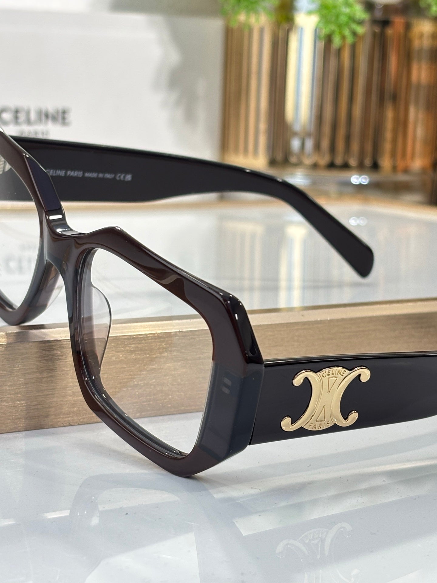 Celine glasses close-up, black frames with gold temple logo and thick rim
