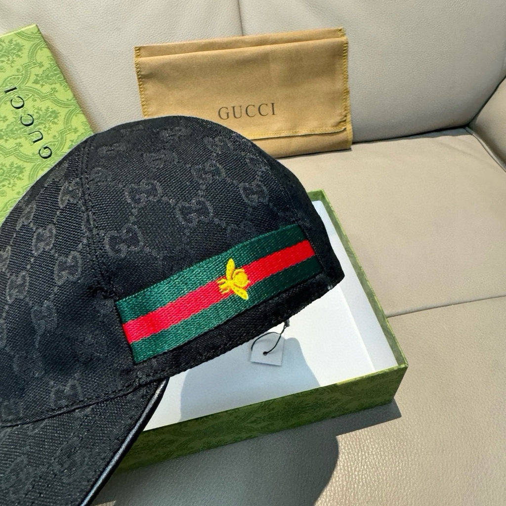 Gucci cap close-up, dark navy GG texture with green-red Web stripe and gold bee patch