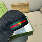 Gucci cap close-up, dark navy GG texture with green-red Web stripe and gold bee patch