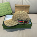 Tan GG canvas baseball cap with green-red web stripe and gold bee emblem.