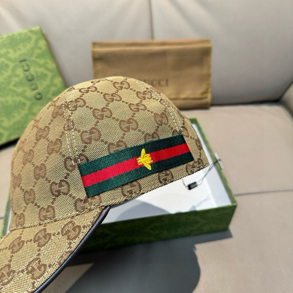 Tan GG canvas baseball cap close-up with green-red web stripe and gold bee.