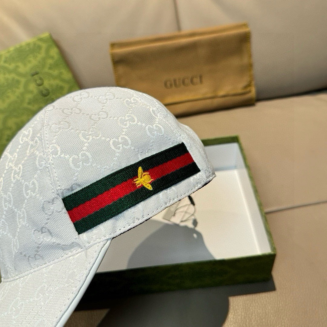 White GG-print baseball cap front with green-red web stripe and gold star patch