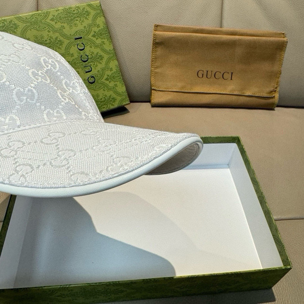 White GG-print baseball cap brim with curved edge and stitched seam