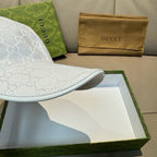 White GG-print baseball cap brim with curved edge and stitched seam