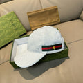 White GG-print baseball cap with green-red web stripe and gold star patch