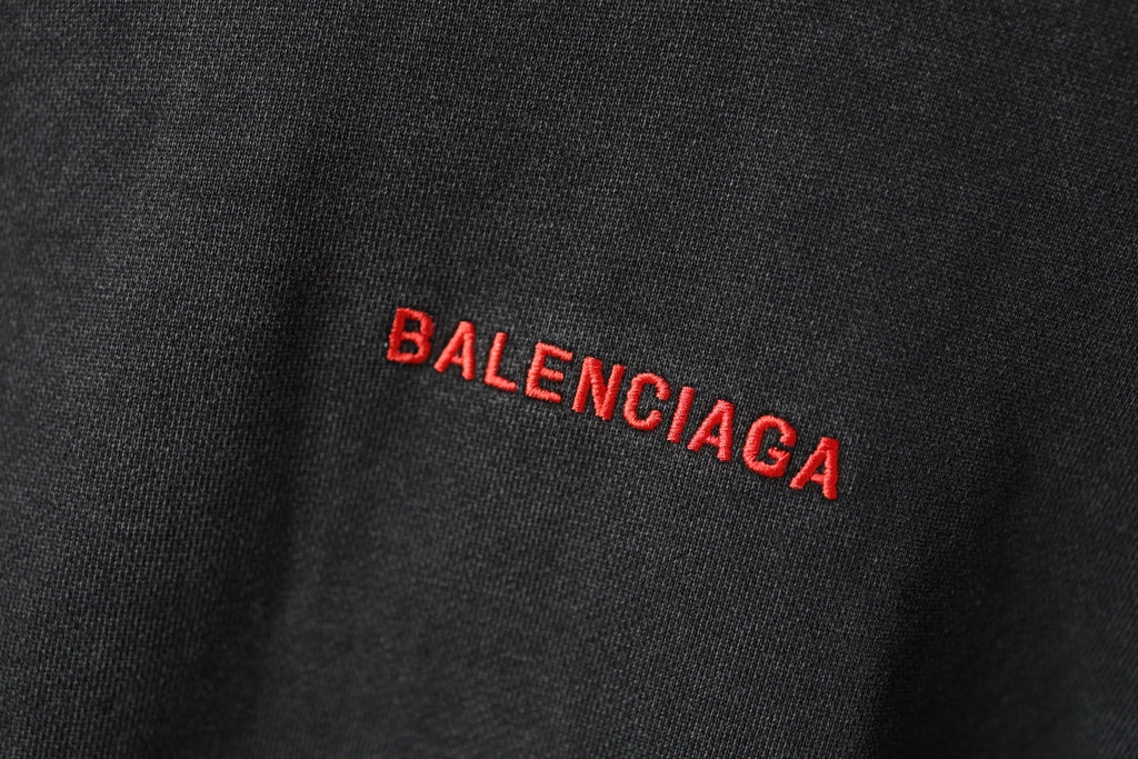 Balenciaga hoodie fabric close-up in dark gray with small red BALENCIAGA mark