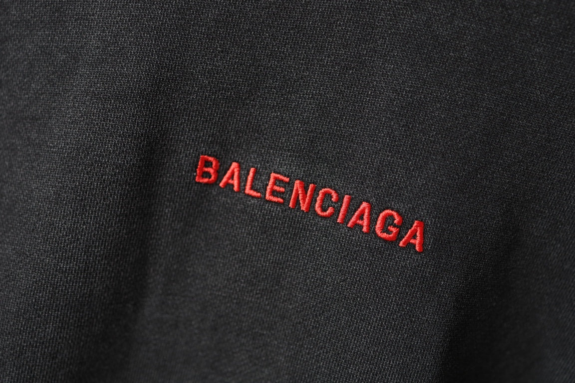 Balenciaga hoodie fabric close-up in dark gray with small red BALENCIAGA mark