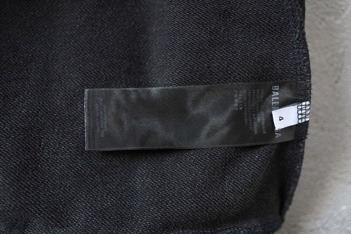 Balenciaga hoodie side label patch on dark gray fabric with woven BALENCIAGA branding
