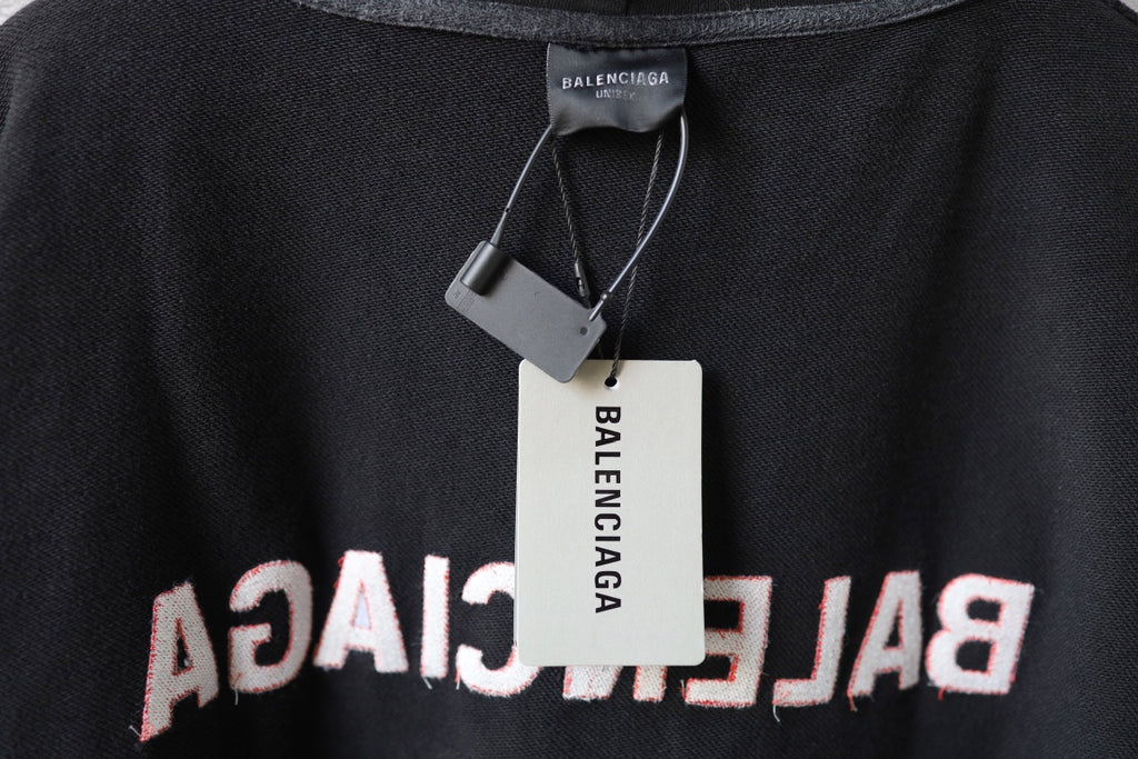 Balenciaga hoodie neckline close-up with inner label tag on dark gray knit fabric
