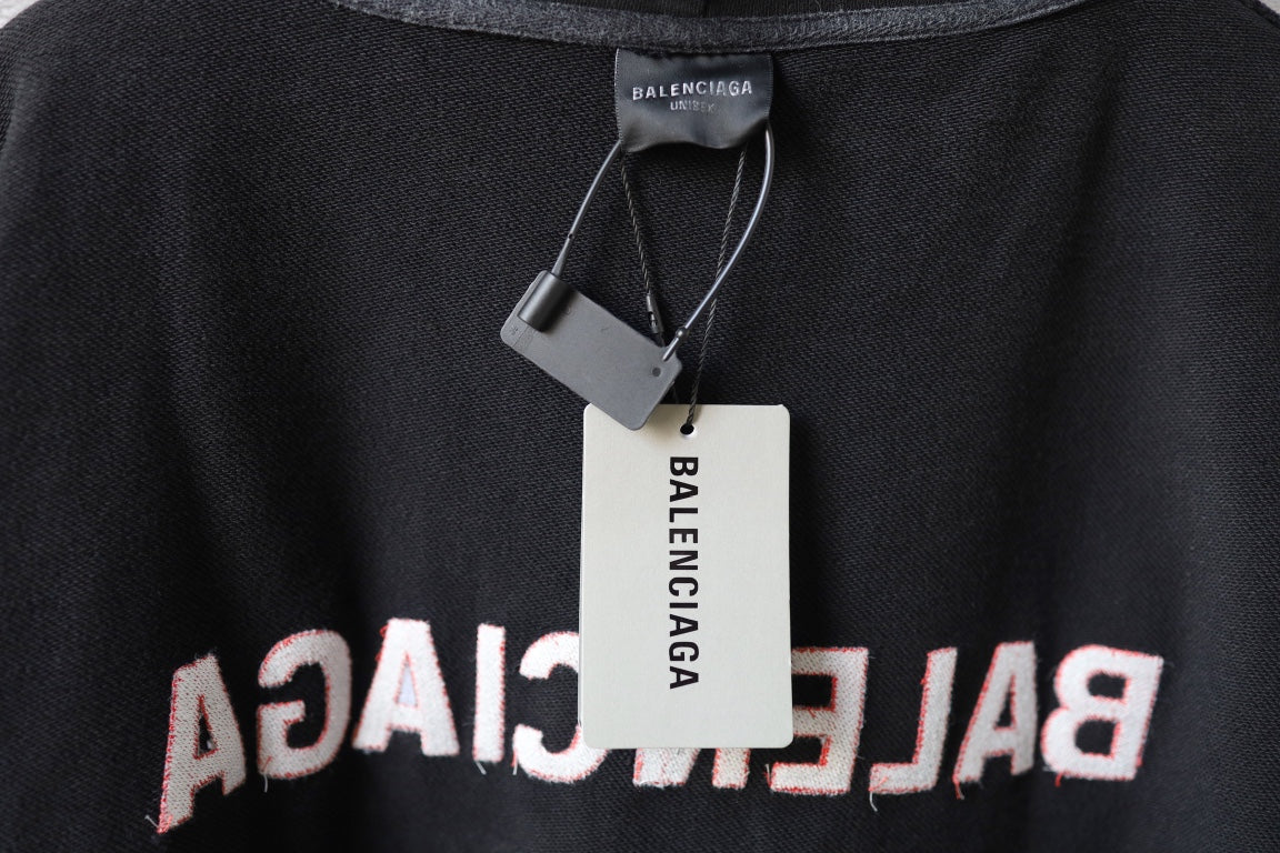 Balenciaga hoodie neckline close-up with inner label tag on dark gray knit fabric