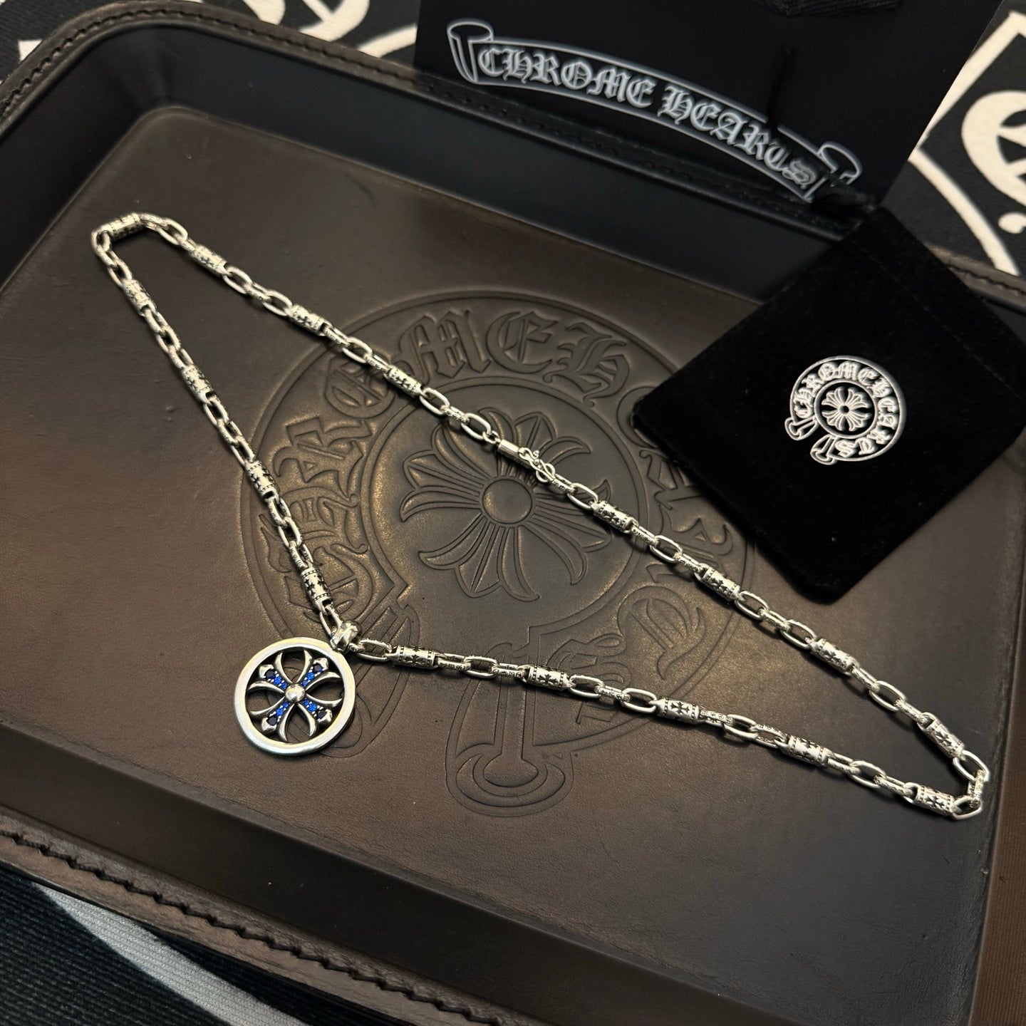 Chrome chain necklace with round blue cross pendant in a gift set tray