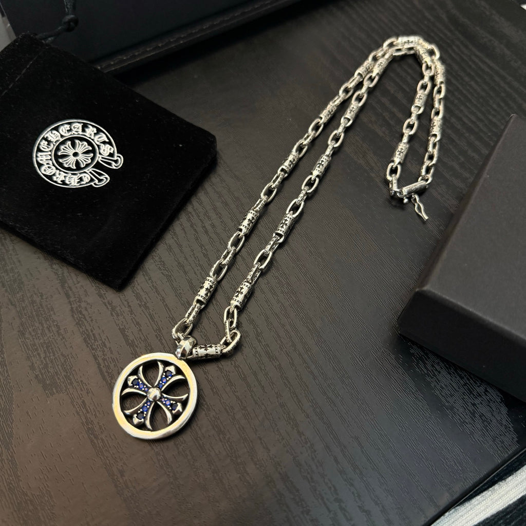 Chrome chain necklace with round medallion pendant featuring blue cross details