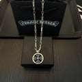 Chrome cross pendant necklace with blue accents in a round silver frame