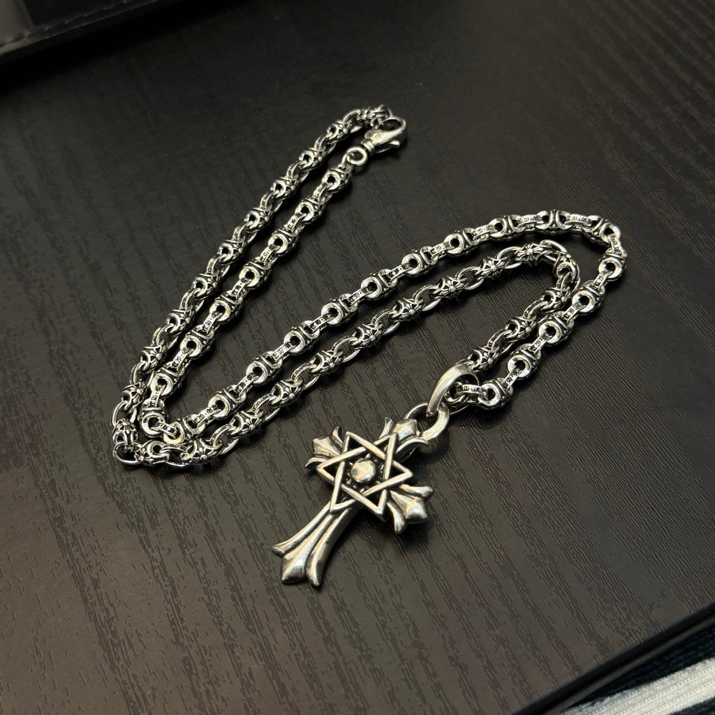 Chrome cross pendant necklace with ornate links and layered chain