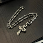 Chrome cross pendant necklace with ornate links and layered chain