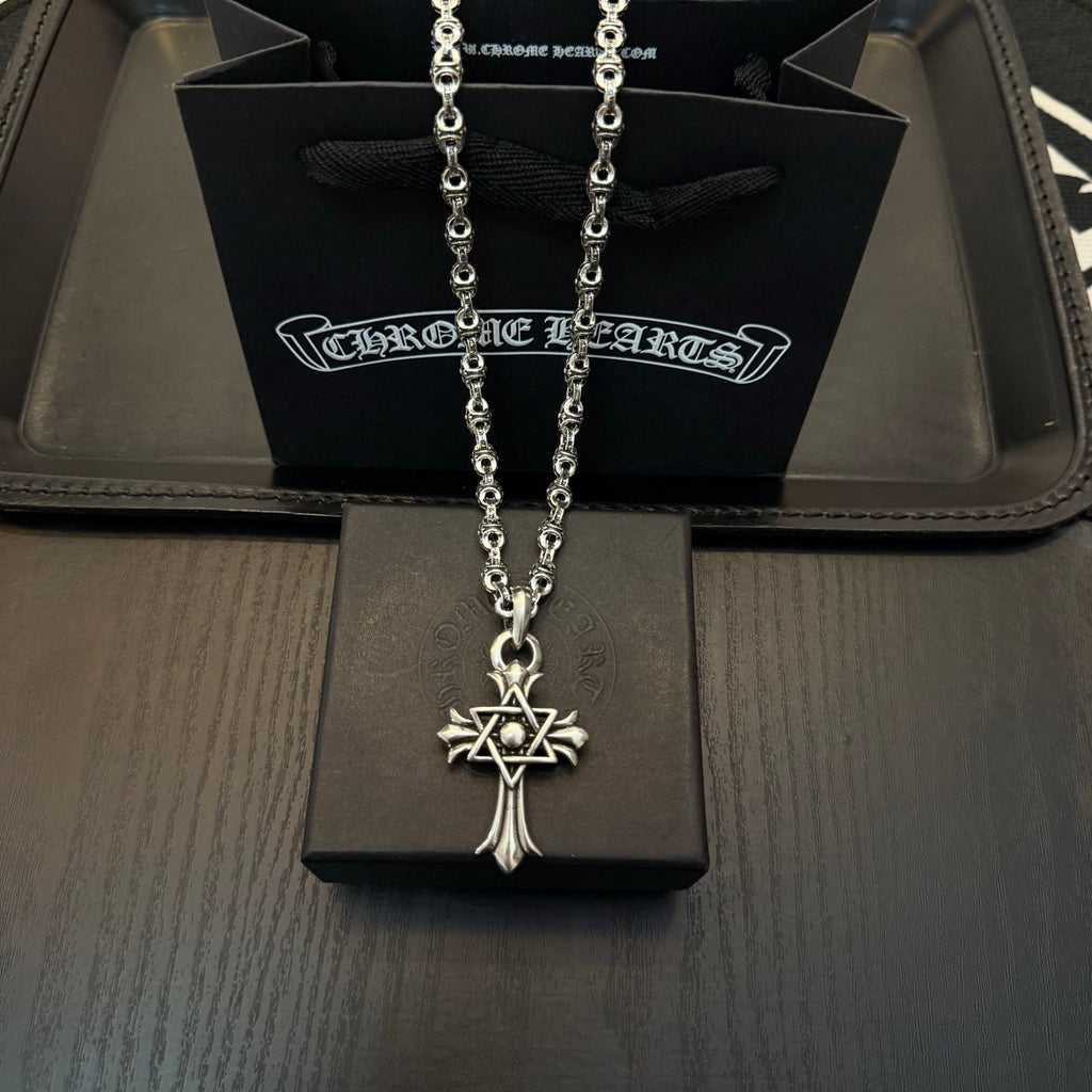 Chrome pendant necklace with star-and-cross charm and long linked chain