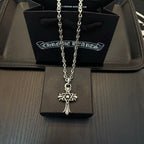 Chrome pendant necklace with star-and-cross charm and long linked chain