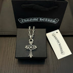 Chrome star-and-cross pendant necklace set in a black jewelry box